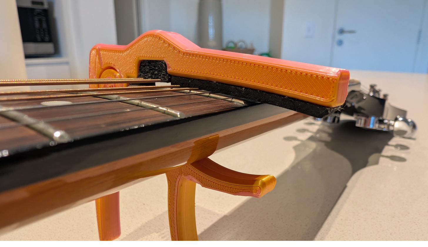 Omega Capo at the fifth fret in ukulele mode, dampening the two lowest strings